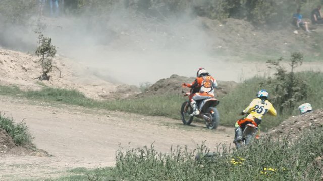 Professional Motocrossers Are Performing a Series of Jumps and Turns on the Race Track. Championship Motocross
