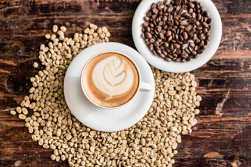 Still life of cappuccino cup and coffee beans