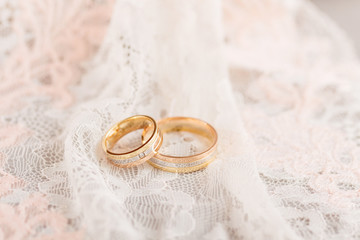 Golden wedding rings on lace