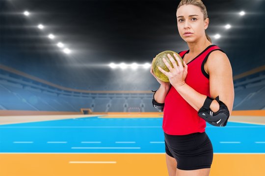 Female athlete with elbow pad holding handball 