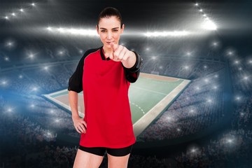 Composite image of female athlete pointing the camera 