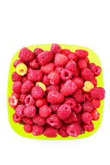 Bowl full of ripe raspberries isolated on white background.