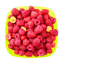 Bowl full of ripe raspberries isolated on white background.