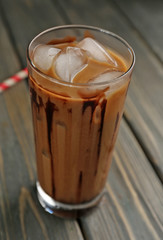 Glass of iced coffee on wooden table
