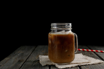 Jar of iced coffee on wooden table