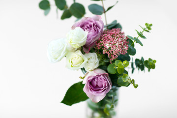 Bouquet of roses in vase on the white background