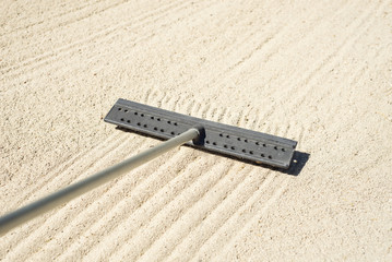 Raking a golf bunker