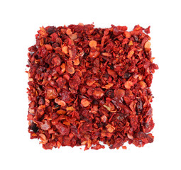 Square of dried chopped chili pepper on white background