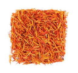 Square of dried saffron on white background