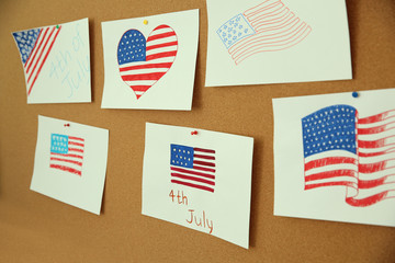 Child's drawings of American flag on cork board