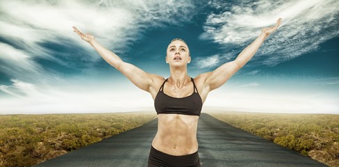 Fototapeta na wymiar Composite image of female athlete raising arms