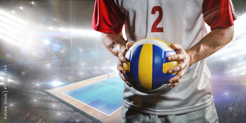 Wall mural Composite image of sportsman holding a volleyball