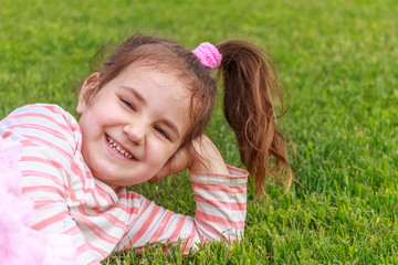 Obraz premium Adorable young child girl in the park. On warm summer day during