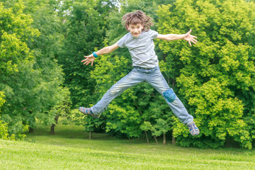 Adorable young child boy in the park. On warm summer day during