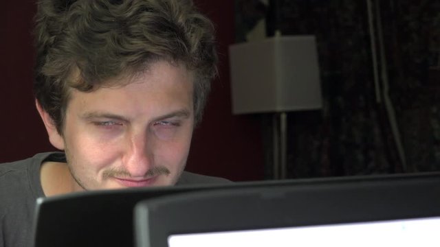 Strange man surfing internet late at night in hotel room.
