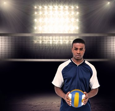 Composite image of sportsman holding a volleyball