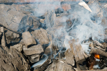 Glowing coals in a barbeque coal fire smoke