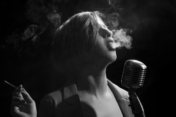 Woman with cigarette and retro microphone