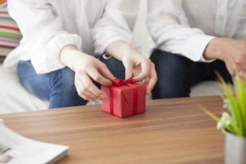 Women are opening the gift box