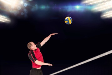 Composite image of sportsman hitting volleyball