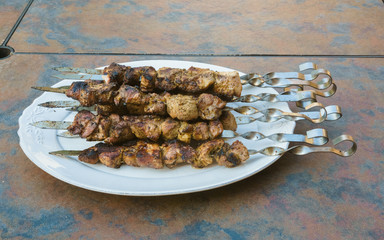 Juicy slices of meat with sauce prepare on fire