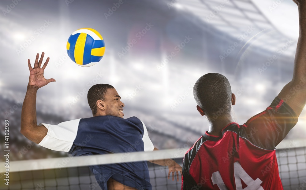 Wall mural Composite image of sportsmen are playing volleyball 