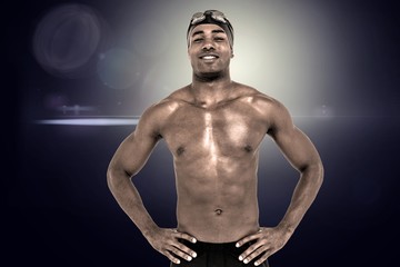 Fototapeta na wymiar Composite image of swimmer smiling and posing with hands on hips