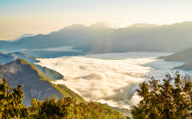 Beautiful morning sunrise, dramatic cloud of sea, giant rocks and Yushan mounatin under bright blue sky in Alishan(Ali mountain) National Park, Taiwan