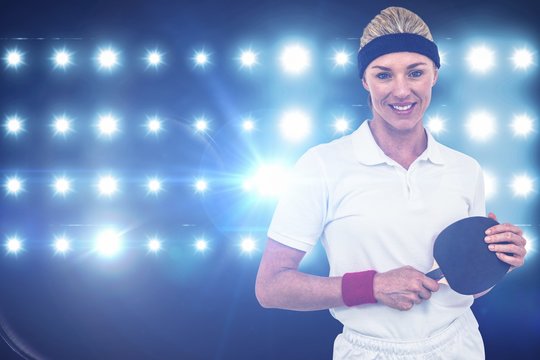 Composite image of female athlete holding a paddle