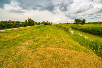Obraz premium river running near eighteenth century church in bucolic landscap