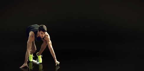 Composite image of sportsman waiting on the starting block