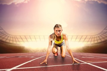 Composite image of sportswoman in the starting block