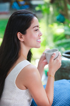 Beautiful asian woman enjoys fresh coffee in the morning. Happy time.