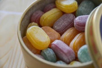 Colorful lollipops on wooden background