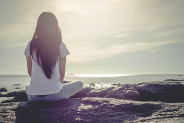 meditating woman at beach