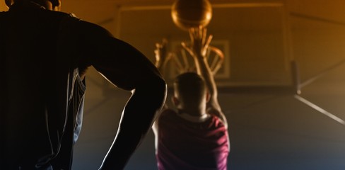 Rear view of a player shooting a basketball