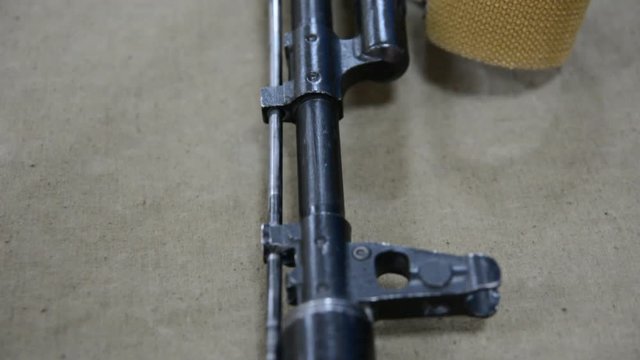 Overview Kalashnikov lying on a cloth on the table