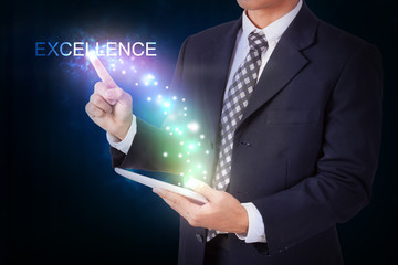 Businessman holding tablet with pressing excellence. internet and networking concept