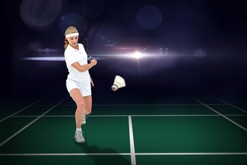 Fototapeta na wymiar Composite image of badminton player playing badminton 