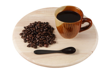 Coffee cup and coffee beans on wood board isolated
