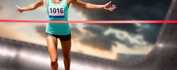 Composite image of sportswoman finishing her run