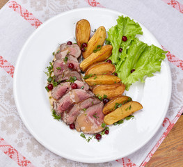 Tasty roasted pork meat with potatoes
