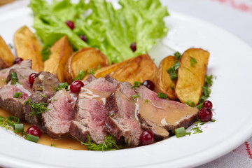 Tasty roasted pork meat with potatoes