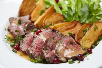 Tasty roasted pork meat with potatoes
