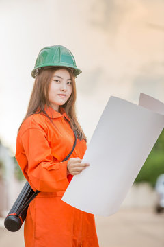 asian woman engineer wearing protective workwear at work