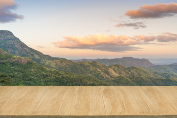 Wood floor with background of mountain view at twilight