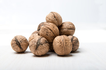 Heap of walnuts on white table