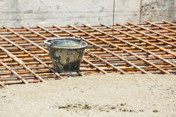 Obraz premium Dirty plastic bucket in construction site