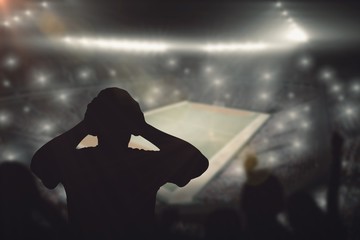 Composite image of silhouettes of football supporters
