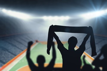 Composite image of silhouettes of football supporters